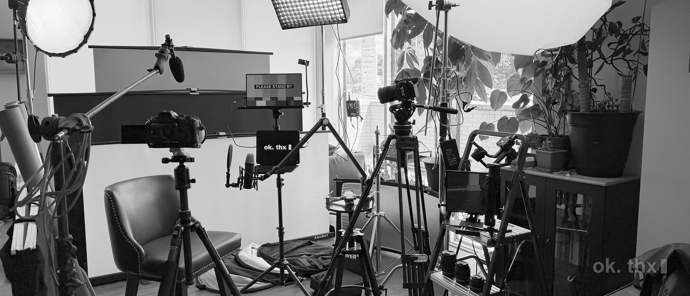 The studio set up for a shoot: lights, stands, monitor and backdrop